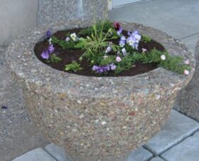 Glacier Precast Concrete flower pot with flowers in it